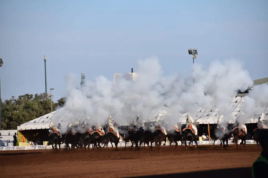 Tbourida fantasia print — Moroccan horsemen charging through gunpowder smoke (BWK-178), photograph by Saida