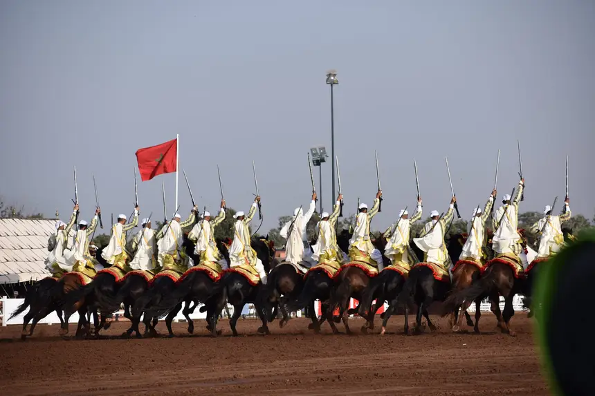 Tbourida fantasia print — Moroccan horsemen charging through gunpowder smoke (BWK-422), photograph by Saida