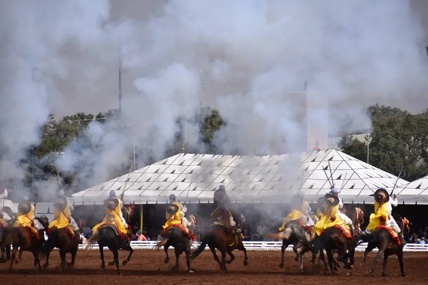 Tbourida fantasia print — Moroccan horsemen charging through gunpowder smoke (BWK-548), photograph by Saida