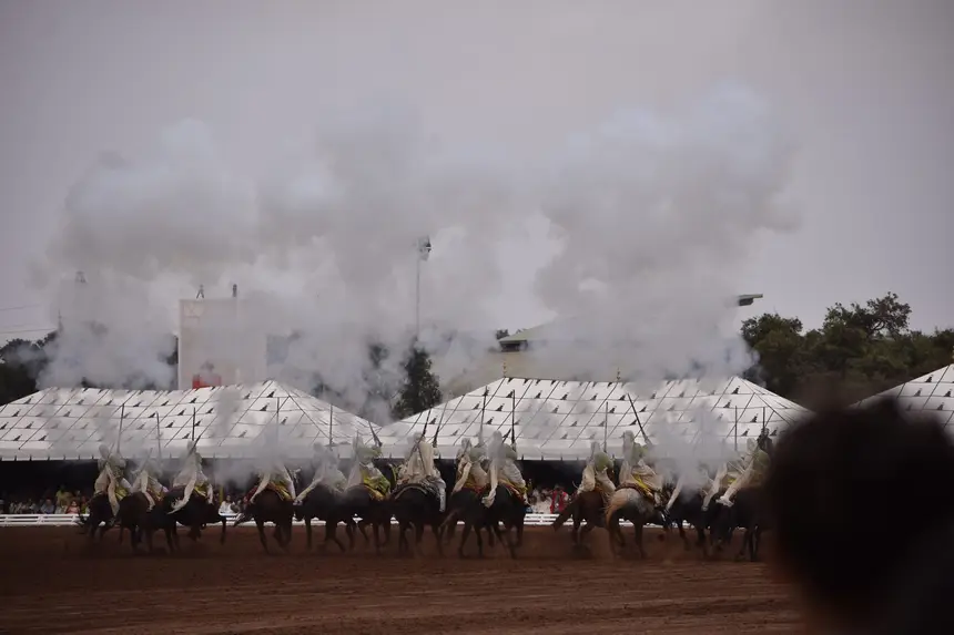 Tbourida fantasia print — Moroccan horsemen charging through gunpowder smoke (BWK-716), photograph by Saida