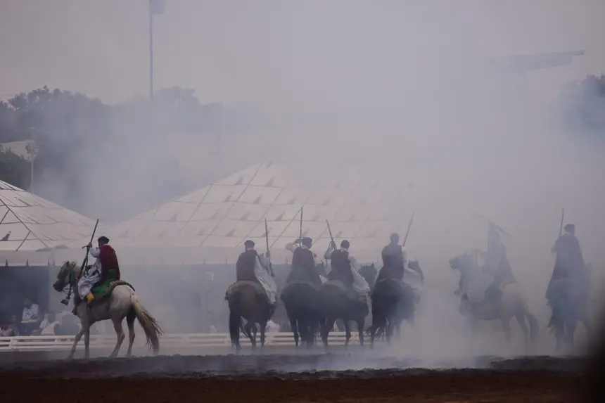Tbourida fantasia print — Moroccan horsemen charging through gunpowder smoke (BWK-724), photograph by Saida