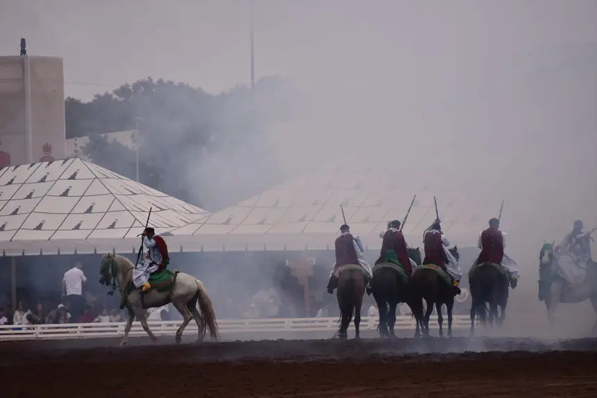 Tbourida fantasia print — Moroccan horsemen charging through gunpowder smoke (BWK-725), photograph by Saida