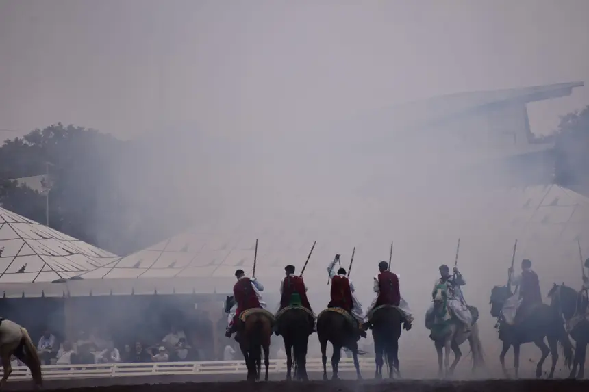 Tbourida fantasia print — Moroccan horsemen charging through gunpowder smoke (BWK-726), photograph by Saida