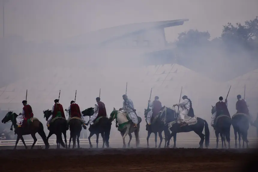 Tbourida fantasia print — Moroccan horsemen charging through gunpowder smoke (BWK-727), photograph by Saida